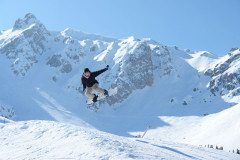 Snowboarder hitting a jump in Courchevel