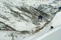 Snowboarder getting airborne in La Grave