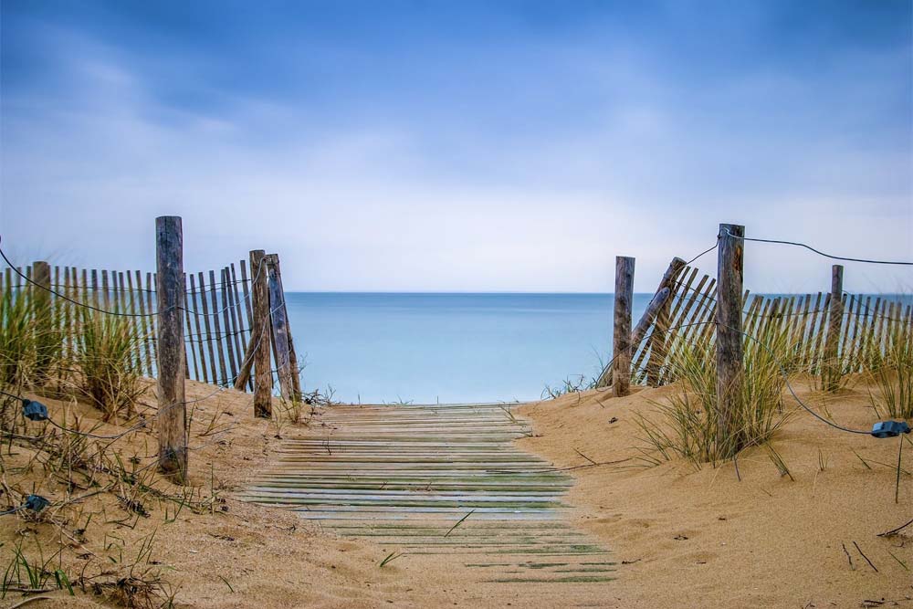 A sandy walkway leads to a blue flag beach on the Ile d'Oléron