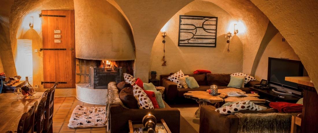 The lounge area and open fire in Chalet Ribot