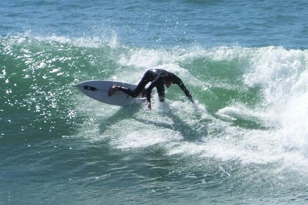 A surfer rips a turn at La Centrale