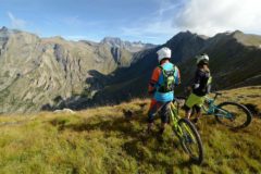 Enduro mountain bikers take a break to enjoy the view in Orcières