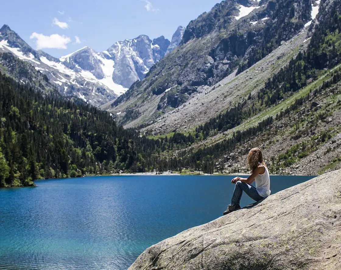 Hiker at Lac de Gaube beneath the north face of the Vignemale