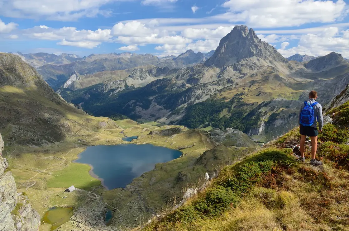 Hiker enjoying the view of the Pic du Midi d'Ossau in the French Pyrenees