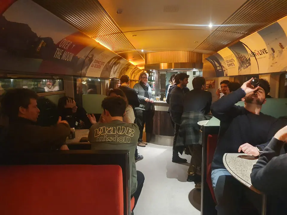 Passengers socialising in the Travelski Night Express cafe bar