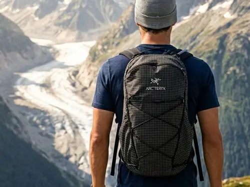 Best Small Backpacks Pascal carrying an Arc'teryx Aerios 18 Backpack in the French Alps