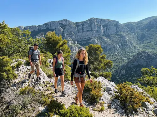 Three hikers in the on a canyon trail in the Gorges du Verdon