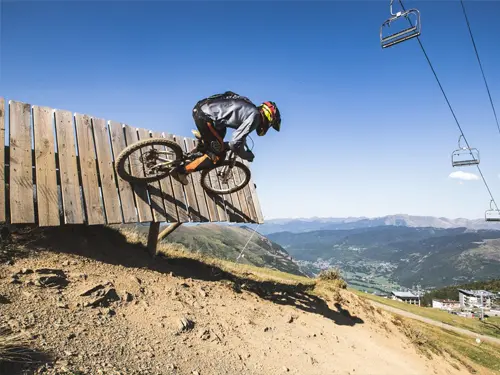 Mountain biker hits a wall-ride in Saint-Lary in the Pyrenees