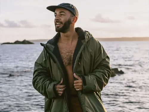 Passenger Waves changing robe Man on the beach wearing a Passenger Waves changing robe