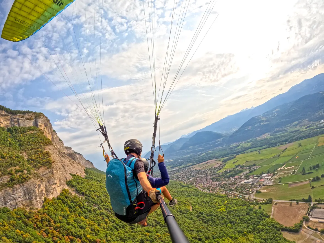 Tandem paraglider soars the ridge at Saint-Hilaire-du-Touvet in the French Alps