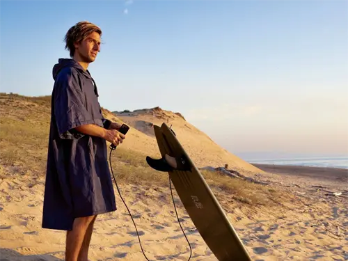 VOITED Surf Poncho Man checking out the waves in Hossegor, France wearing a VOITED Surf Poncho