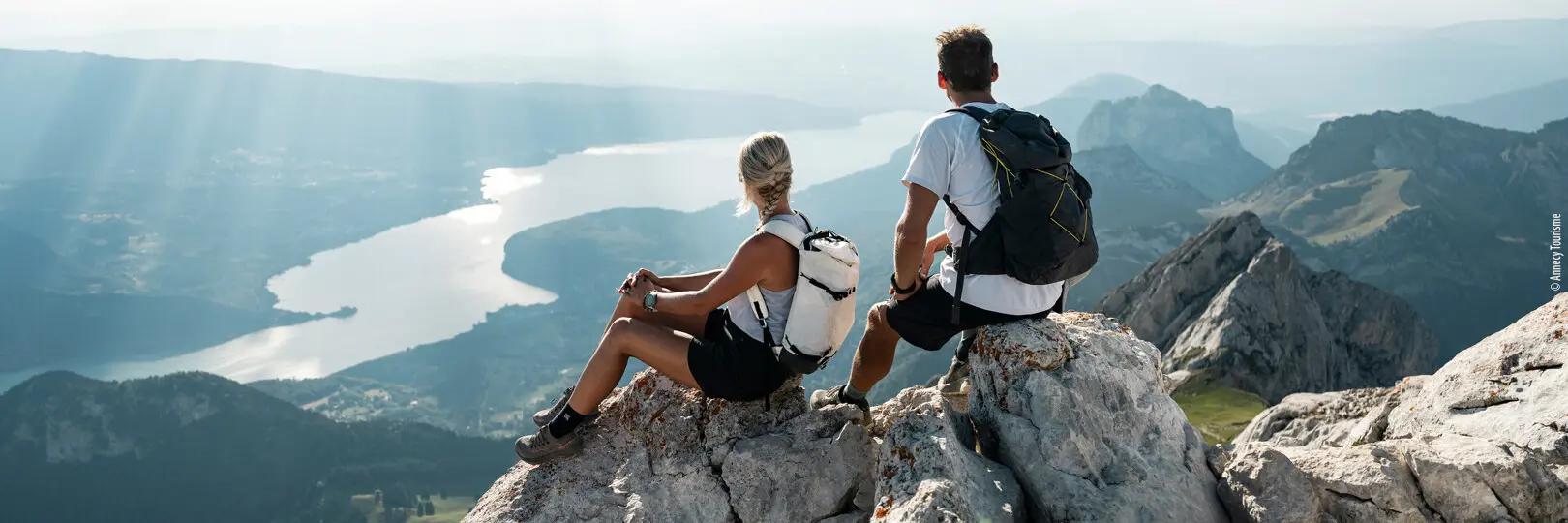 Hikers looking out over Lake Annecy from La Tournette