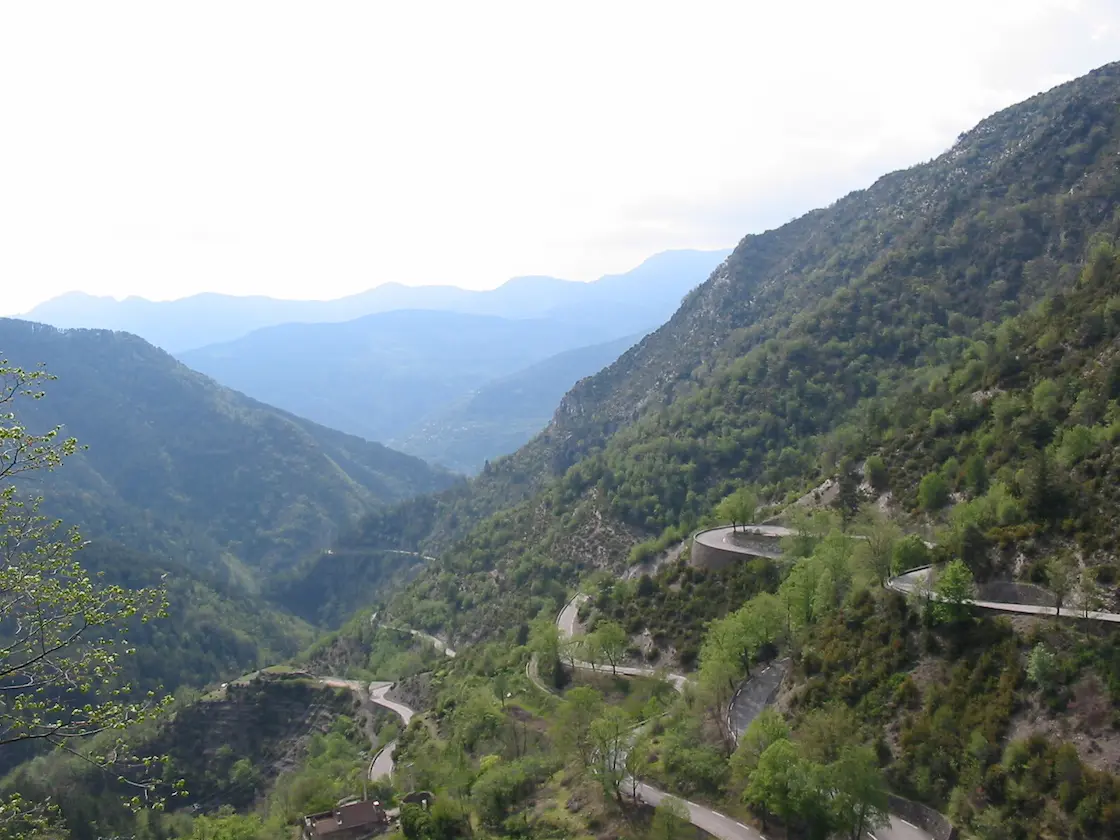 Road cyclist on the hairpins of the Col de Turini above Sospel