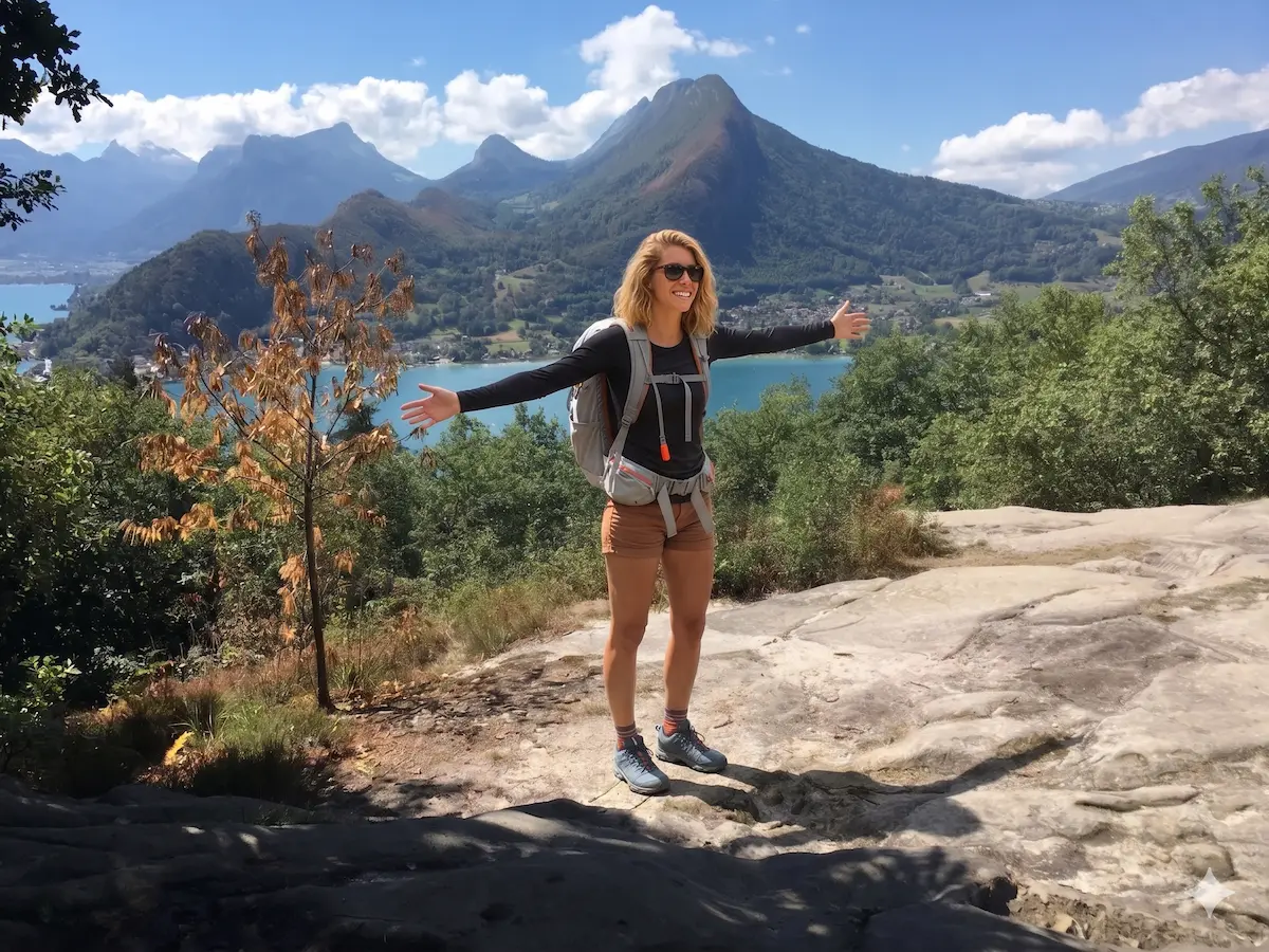 Hiker enjoying the view over Annecy Lake from Roc de Chère Nature Reserve