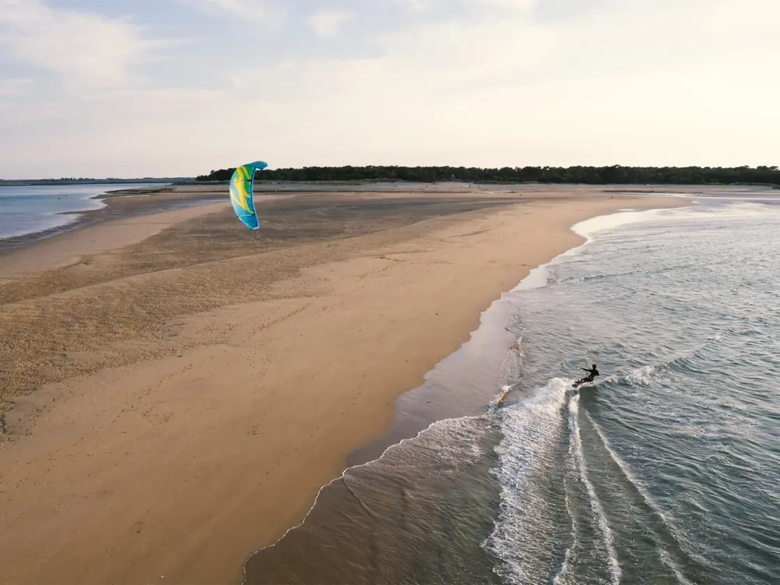 Kitesurfer blasts across the wind on Ile de Ré, France