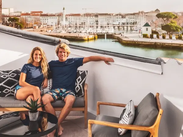 La Rochelle Hotel Accommodation two people relaxing on the rooftop of a hotel on the old port in La Rochelle, France