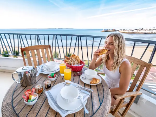 Seafront hotel accommodation in Royan Léa eating a croissant at her seafront hotel in Royan, France