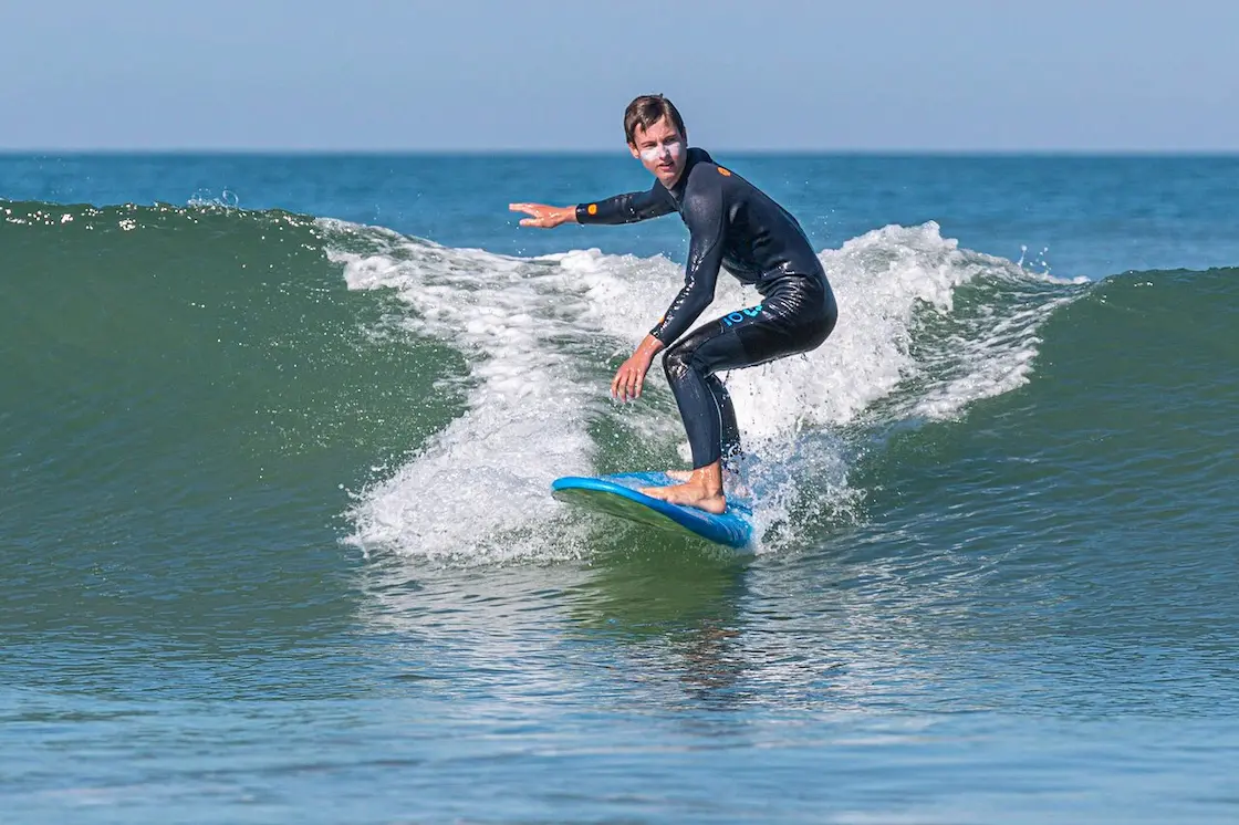 A surfer rides a clean wave on Île d'Oléron in southwest France.